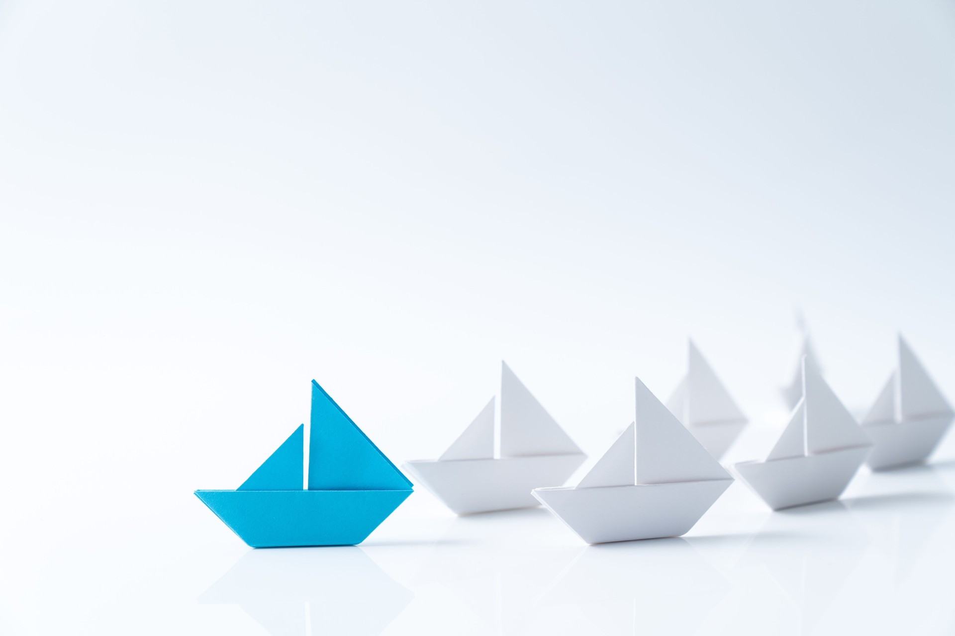 Leadership conceptual using blue paper ship